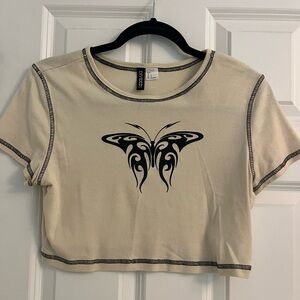 Tan crop top with a butterfly